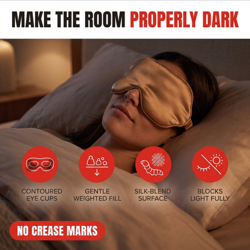 Troveze Contoured Weighted Silk Sleep Mask: Hero shot person wearing mask in bed