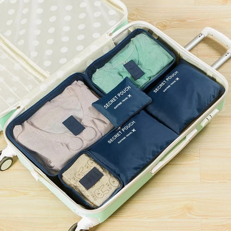Troveze Foldable Travel Packing Cubes (Set of 6): navy blue six-piece set filling an open suitcase